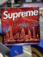 Supreme Logo Text Stencil-painted bold word logo on canvas with matte paint texture