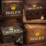 Rolex logo stencil applied on luxury green watch boxes with gemstone accents (yellow crown + white text)