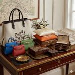 Hermès Paris stencil logo painted on a velvet jewelry box, orange hoodie, wooden drawer, and throw pillow in a square collage.